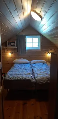 a large bed in a room with a ceiling at Stalheim Fjord og Fjellhytter in Stalheim