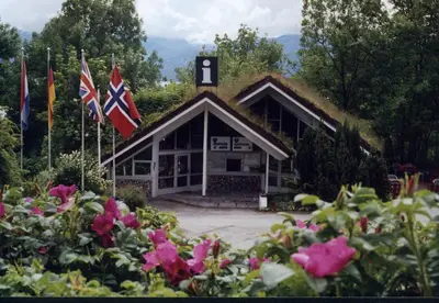 a building with two flags in front of it at Hardanger Feriesenter Nesvika in Norheimsund
