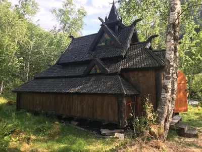 a small house with a roof in the woods at Øren Hotel in Høyanger