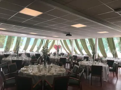 a banquet hall with tables and chairs and tablesearcher at Øren Hotel in Høyanger