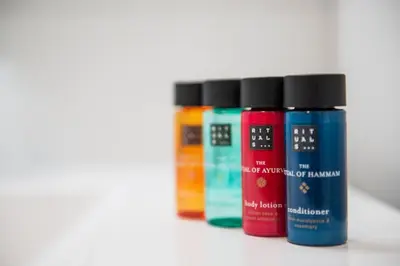 a row of four different colored liquids on a shelf at Leikanger Fjordhotel - Unike Hoteller in Leikanger
