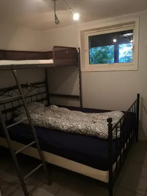 a bedroom with two bunk beds and a window at Malvik, Hundhamaren, Trondheim in Malvik