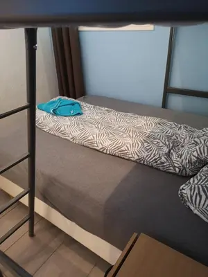 a bunk bed with a blue bag sitting on it at Malvik, Hundhamaren, Trondheim in Malvik