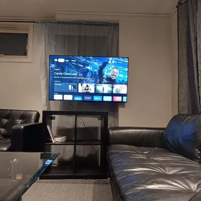 a living room with a couch and a flat screen tv at Malvik, Hundhamaren, Trondheim in Malvik
