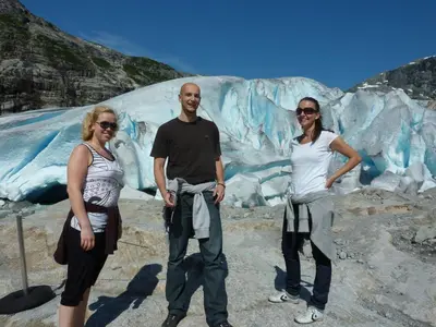 a group of three people standing in front of a glacier at Eikum Hotel in Hafslo