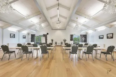 a large room with tables and chairs and chandeliers at Nordfjord Hotell in Nordfjordeid