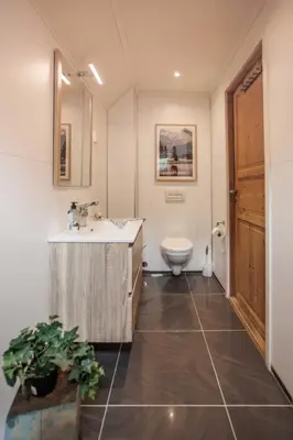 a bathroom with a sink and a toilet at Eastside Cottages in Bømlo