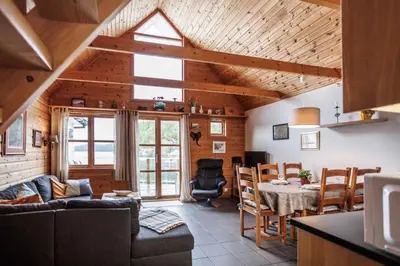 a living room with a couch and a table at Eastside Cottages in Bømlo