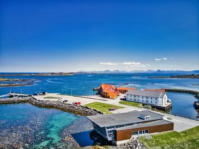 an aerial view of a house and the water at Finnøy Bryggehotell - by Classic Norway Hotels in Finnøy