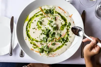 a person eating a plate of food on a table at Finnøy Bryggehotell - by Classic Norway Hotels in Finnøy