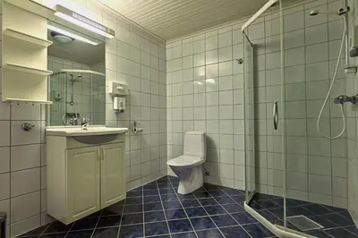 a bathroom with a toilet and a sink and a shower at Ona Havstuer - by Classic Norway Hotels in Ona