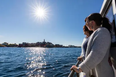 two women on a boat on the water at Ona Havstuer - by Classic Norway Hotels in Ona