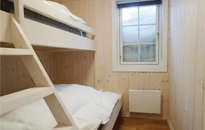 a small room with a bunk bed and a window at Cozy Home In Lillehammer With Wifi in Lillehammer