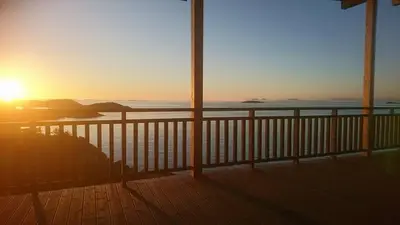 a view of the ocean from a deck at sunset at Værlandet Havhotell in Hamna