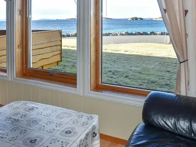 a room with two windows with a view of the ocean at 6 person holiday home in Aukra in Aukra