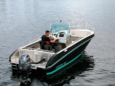 a man in a boat on the water at 6 person holiday home in Aukra in Aukra