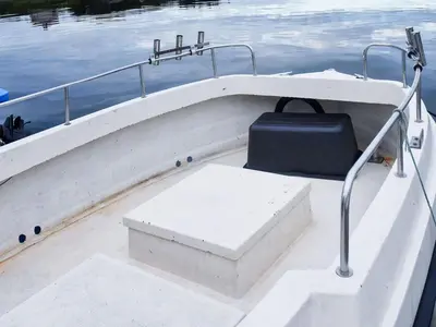 a white boat with a bench in the middle of the water at 6 person holiday home in Aukra in Aukra