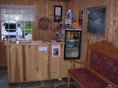 a wooden room with a counter and a refrigerator at Lunde Turiststasjon in Skei