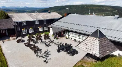 an aerial view of a building with tables and chairs at Gomobu Fjellstue in Ron