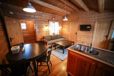 a kitchen and living room in a log cabin at Vesterland Feriepark Hytter, hotell og leikeland in Sogndal