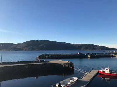 a marina with boats docked in the water at Bakkevik Brygge in Kalvåg