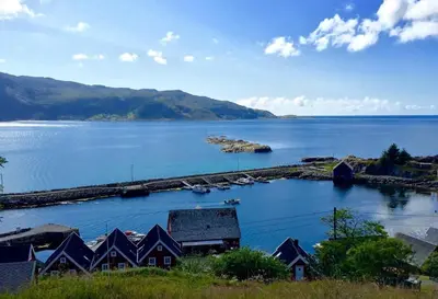 a view of a large body of water with houses at Bakkevik Brygge in Kalvåg