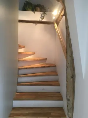 a staircase in a house with wood treads at Bakkevik Brygge in Kalvåg