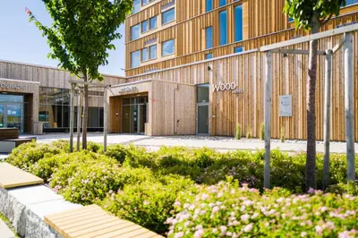 a building with a garden in front of it at Wood Hotel by Frich's in Brumunddalen