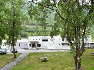 a white building with cars parked in front of it at Birkelunden Bed & Breakfast in Rjukan