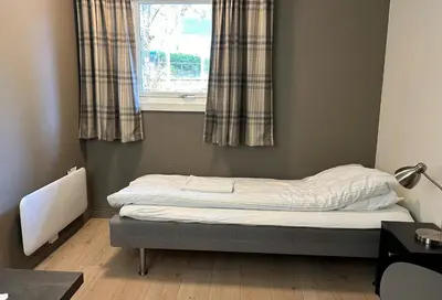 a small bed in a room with a window at Birkelunden Bed & Breakfast in Rjukan