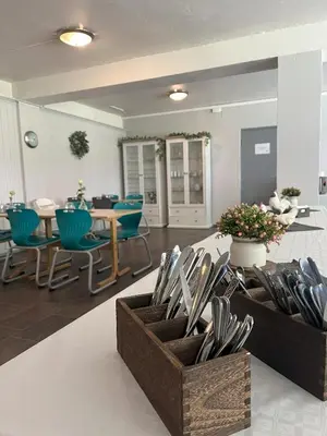 a dining room with a table and blue chairs at Birkelunden Bed & Breakfast in Rjukan