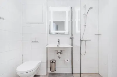 a bathroom with a toilet and a sink and a shower at Frich's Hotell og Spiseri Alvdal in Alvdal