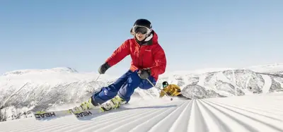 a person is skiing down a snow covered slope at Torsetlia in Dagali