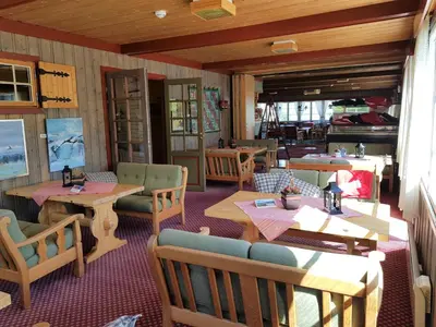 a restaurant with tables and chairs in a room at Torsetlia in Dagali