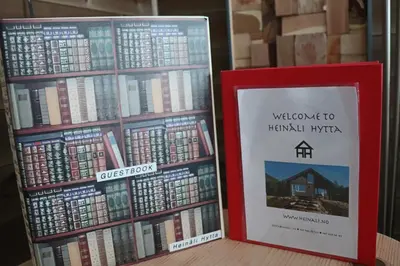 two books sitting next to each other on a shelf at Heinåli Hytta in Isfjorden