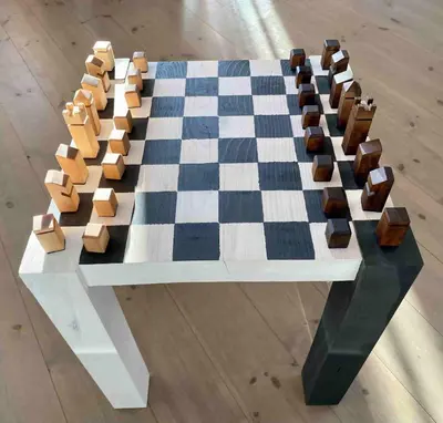 a chess board on a table with a checkerboard at Heinåli Hytta in Isfjorden