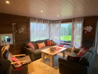 a living room with a couch and a table at Heinåli Hytta in Isfjorden