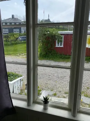 a window with a view of a yard at Solvang Ferietun in Vangsnes