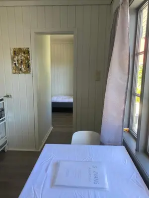 a room with a table with a paper on it at Solvang Ferietun in Vangsnes