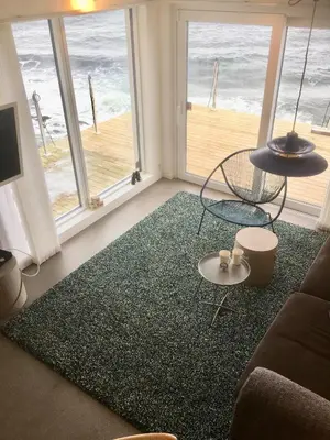 a living room with a view of the ocean at Seaside Rentals in Trondheim