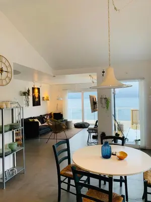 a dining room and living room with a table and chairs at Seaside Rentals in Trondheim