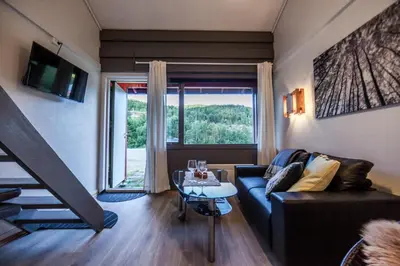 a living room with a couch and a table at Maristova apartment 109 in Filefjell