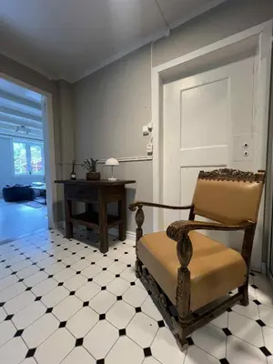 a room with a chair sitting on a tiled floor at Stryn - house by the river in Stryn