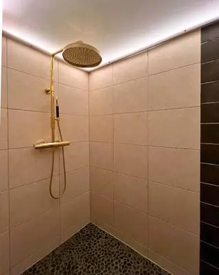 a bathroom with a shower with a shower head at Stryn - house by the river in Stryn