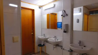 a bathroom with two sinks and two mirrors at Birkelund camping in Geilo