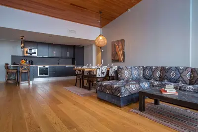 a living room with a couch and a table and a kitchen at Skistar Lodge Trysil in Trysil