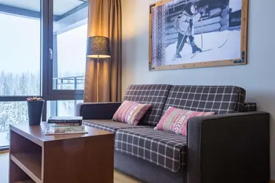 a living room with a couch and a table at Skistar Lodge Trysil in Trysil