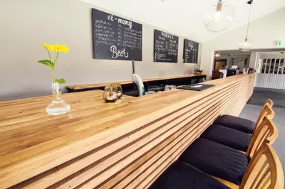 a long wooden bar in a restaurant with two chairs at Rondane Høyfjellshotell in Mysusæter