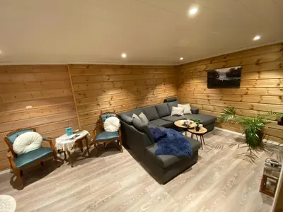 a living room with a couch and two chairs at Sunde panorama in Olden