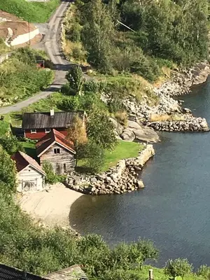 an aerial view of a house next to a river at Bodvarstova in Stryn